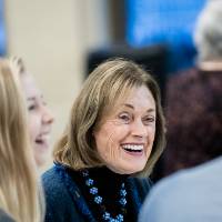 Donna Brooks laughing with guests.